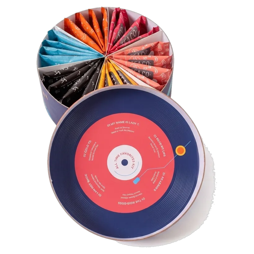 Tea set box lid held in the hand, record-sleeve artwork printed on the inside face of the lid disc